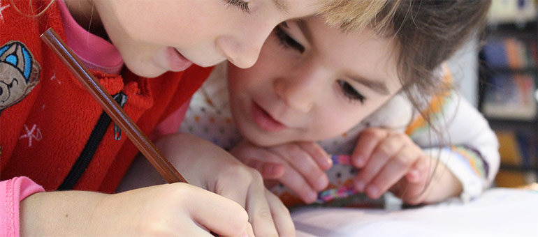 Two girls collaborating and writing