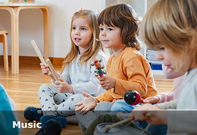 A young class sit playing musical instruments