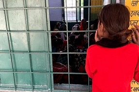 Girl looking into classroom window