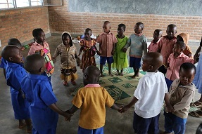 Primary school children singing in a circle Rwanda