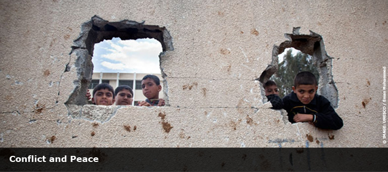 children looking through holes in teh wall