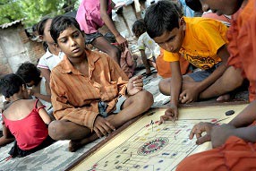 Boys playing carrom a popular board game in India