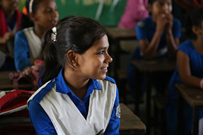 A smiling student in class at Azimpur Government Primary School. Dhaka Bangladesh