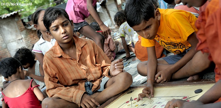 Boys playing carrom a popular board game in India 