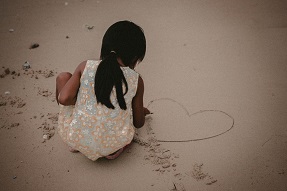 Young girls plays in the sand India