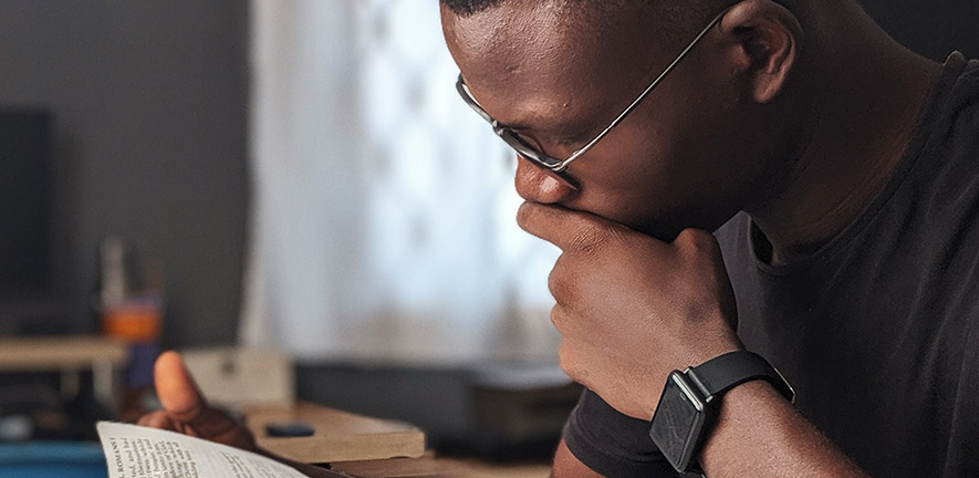 A student sits reading intently