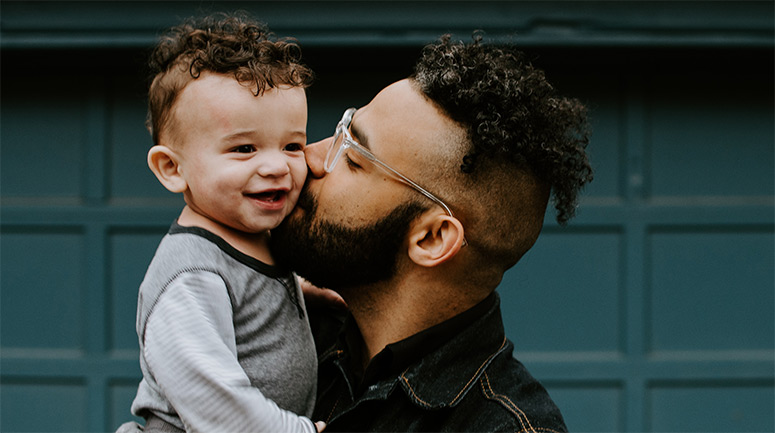 Man carrying child | unsplash