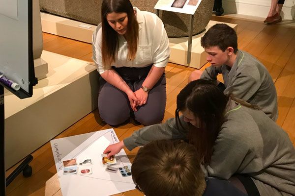 Children and teacher discussing Egyptology